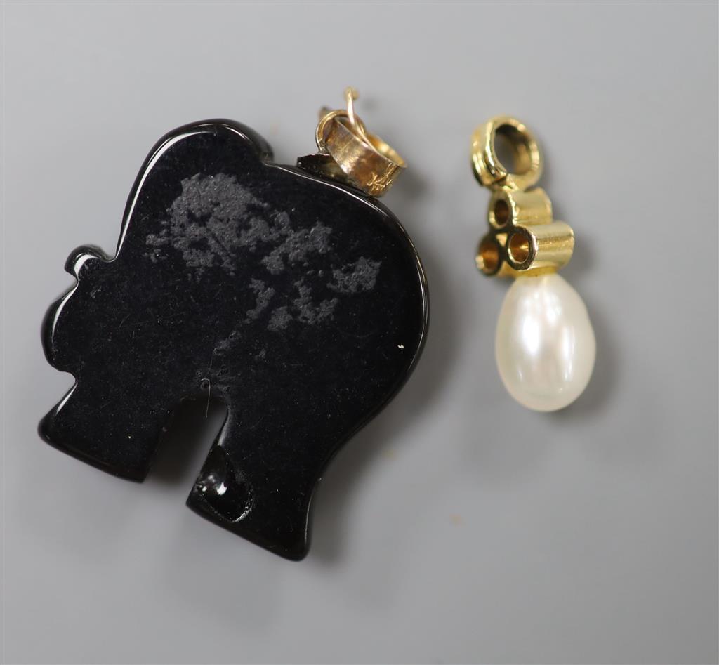 A modern yellow metal, single cultured pearl and three stone diamond chip set pendant, 16mm, gross 0.8 grams & elephant charm.